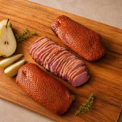 Gourmet sliced duck breast on wooden board