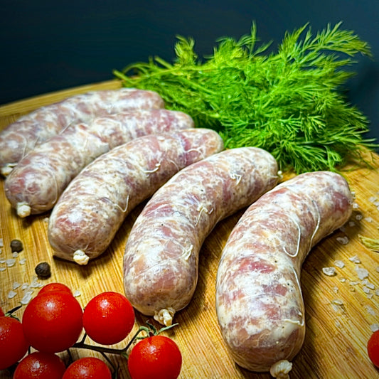 Fresh Pork Sausages for Grilling raw links on wooden board with herbs – Ukrainian Smokehouse