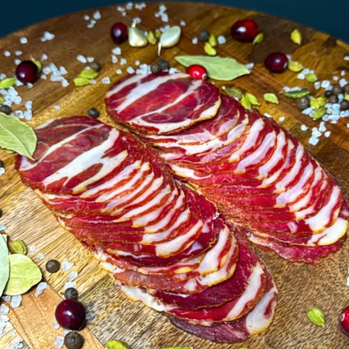 Capocollo style cured pork showing marbling and spice coating – Ukrainian Smokehouse