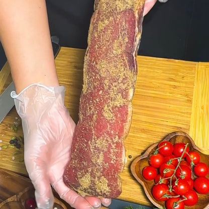 Whole Polandvica dry-cured pork loin held by hand – Ukrainian Smokehouse