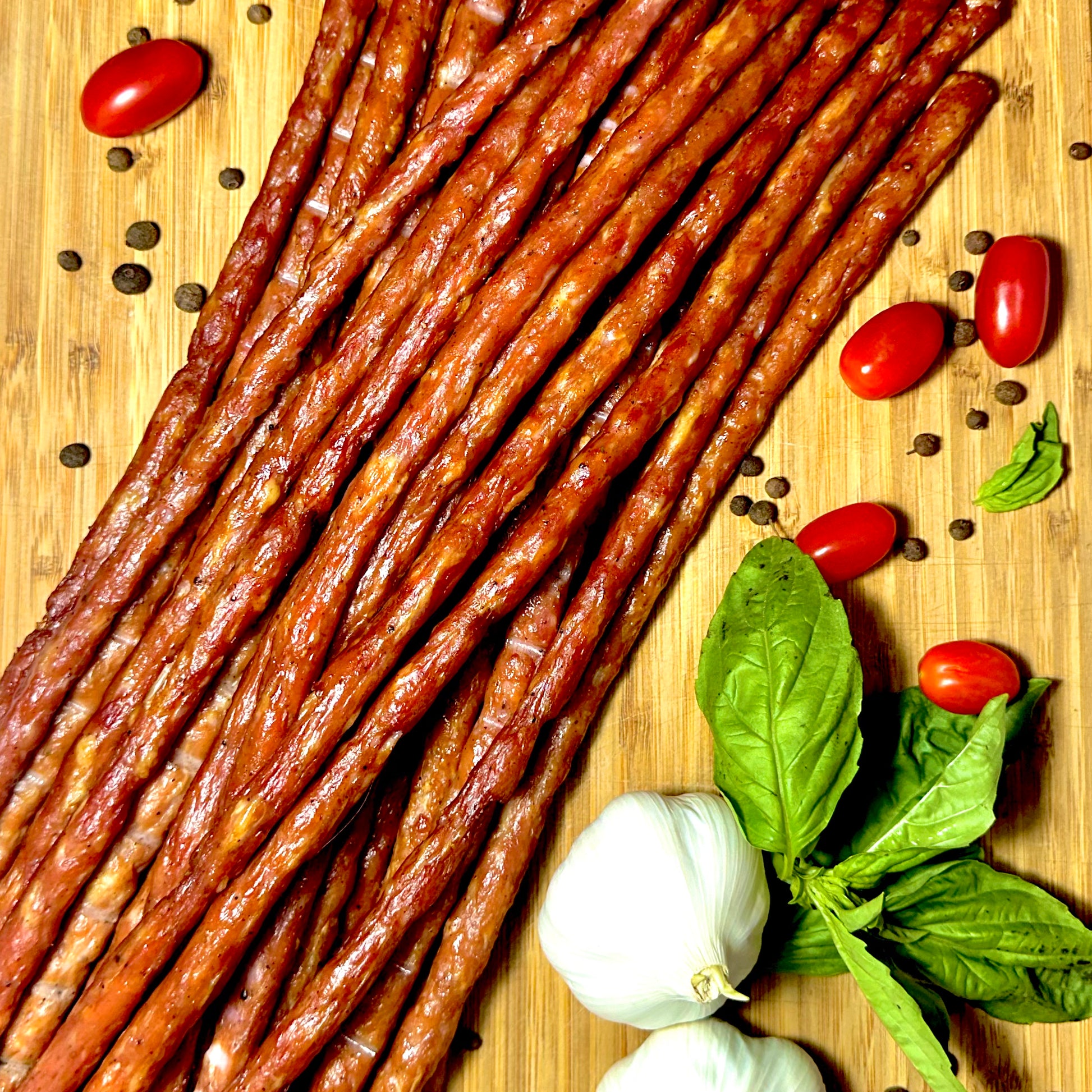 Chicken snack sticks close up on wooden board with herbs